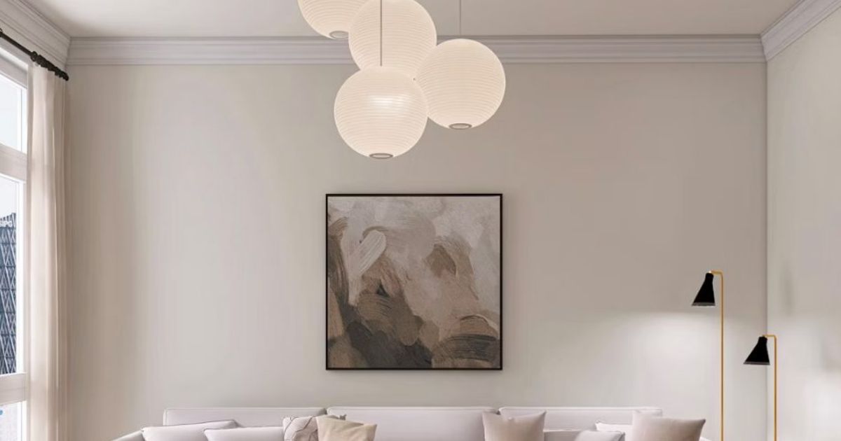 Pendant lights above a living room wall with a framed abstract artwork